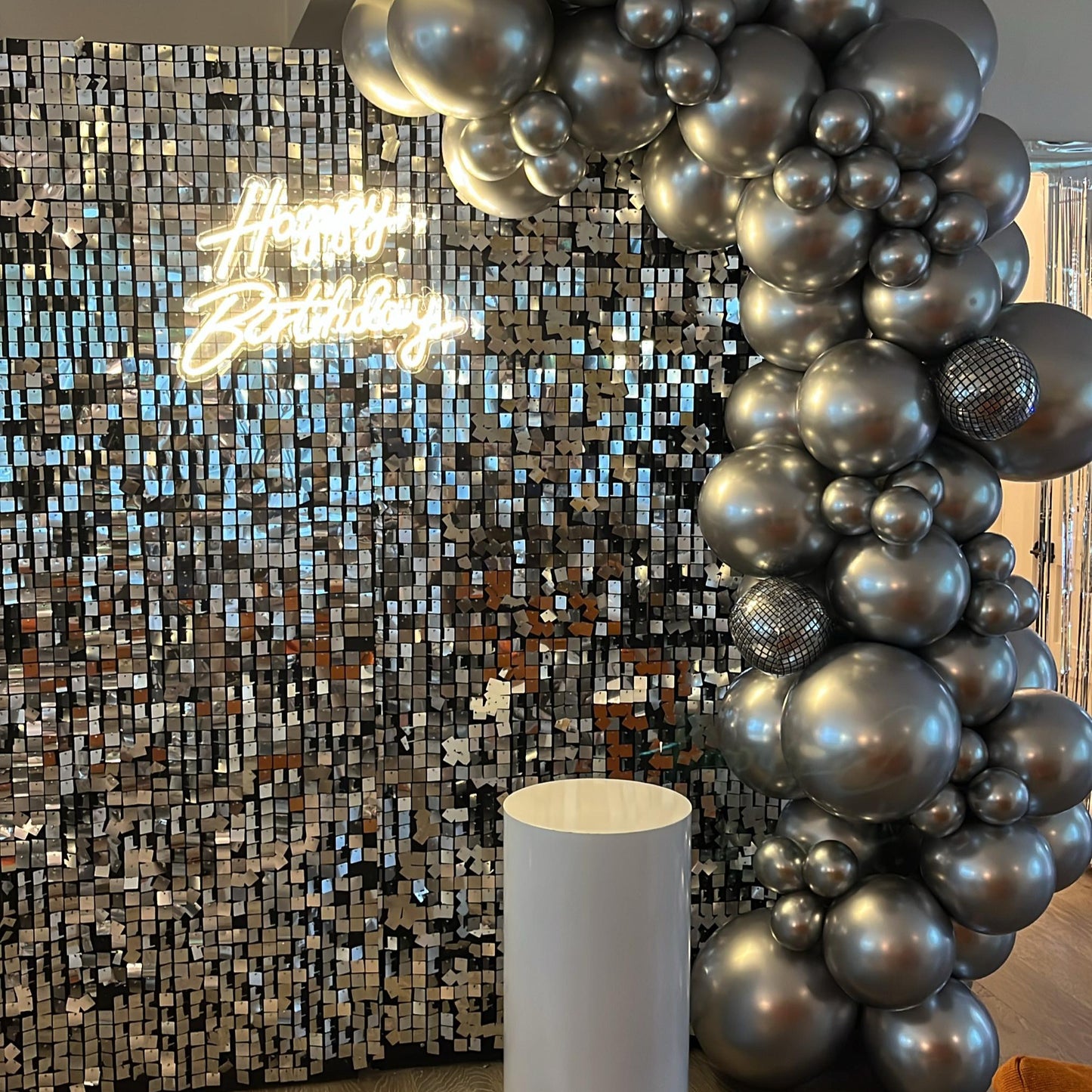 Shimmer disco wall with balloon garland