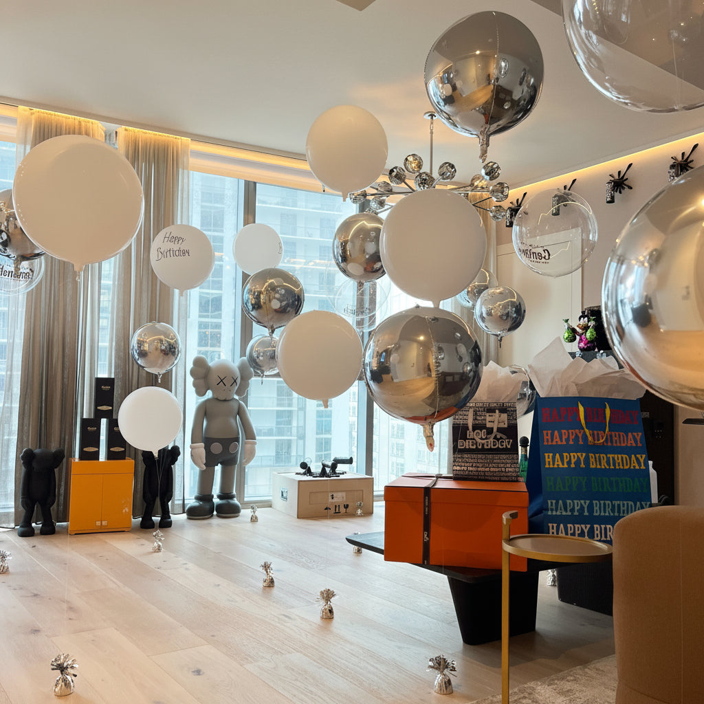 Decorative room with hanging balloons and birthday-themed decorations.