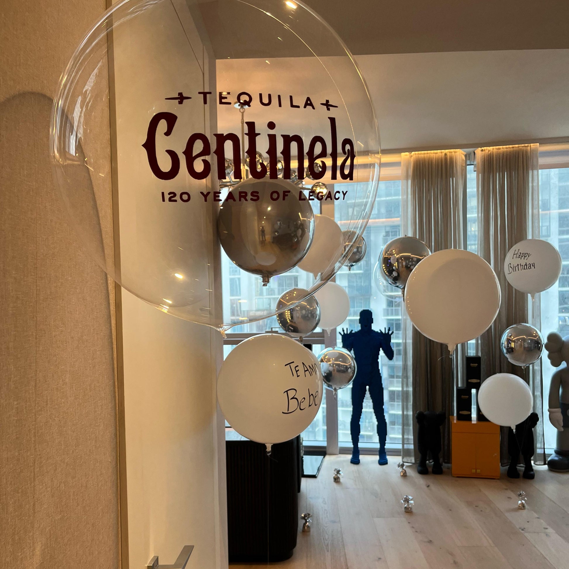 Tequila Centinela display with balloons in a room with large windows.