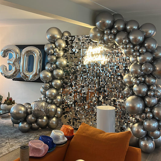 Shimmer disco wall with balloon garland